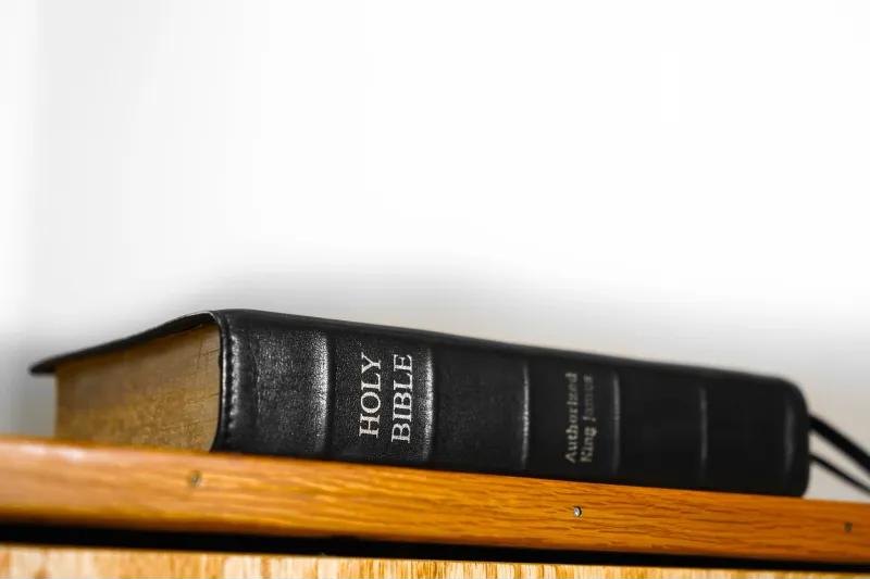 A King James Bible on a wooden shelf