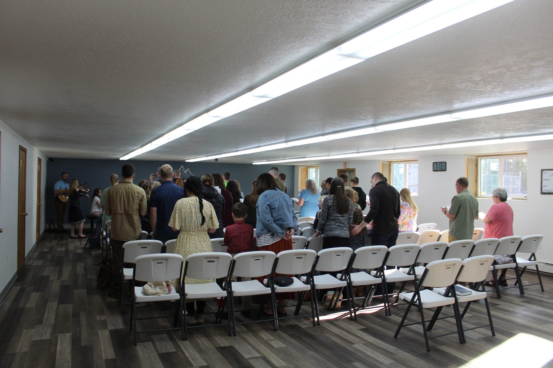 Church family visiting in the fellowship hall after the service